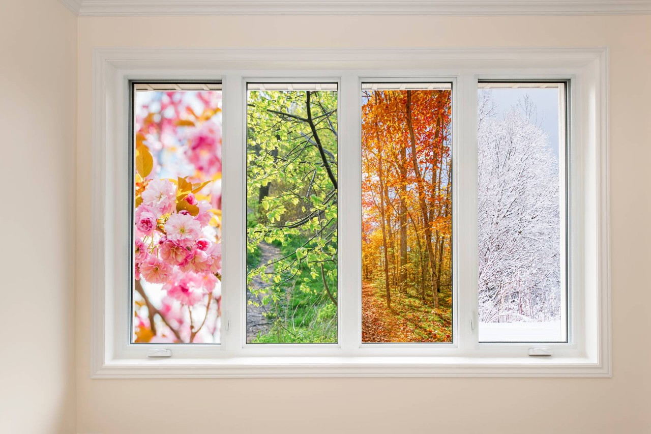 A window with four panels that depict the seasons from spring to winter, left to right at Captivating Windows by Magnolias near Norfolk, NE