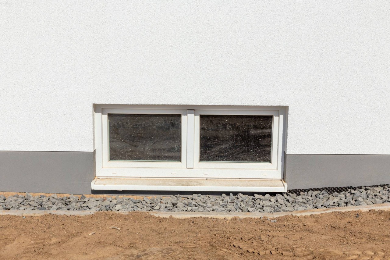 The exterior of a new construction with a basement hopper window near Norfolk, Nebraska